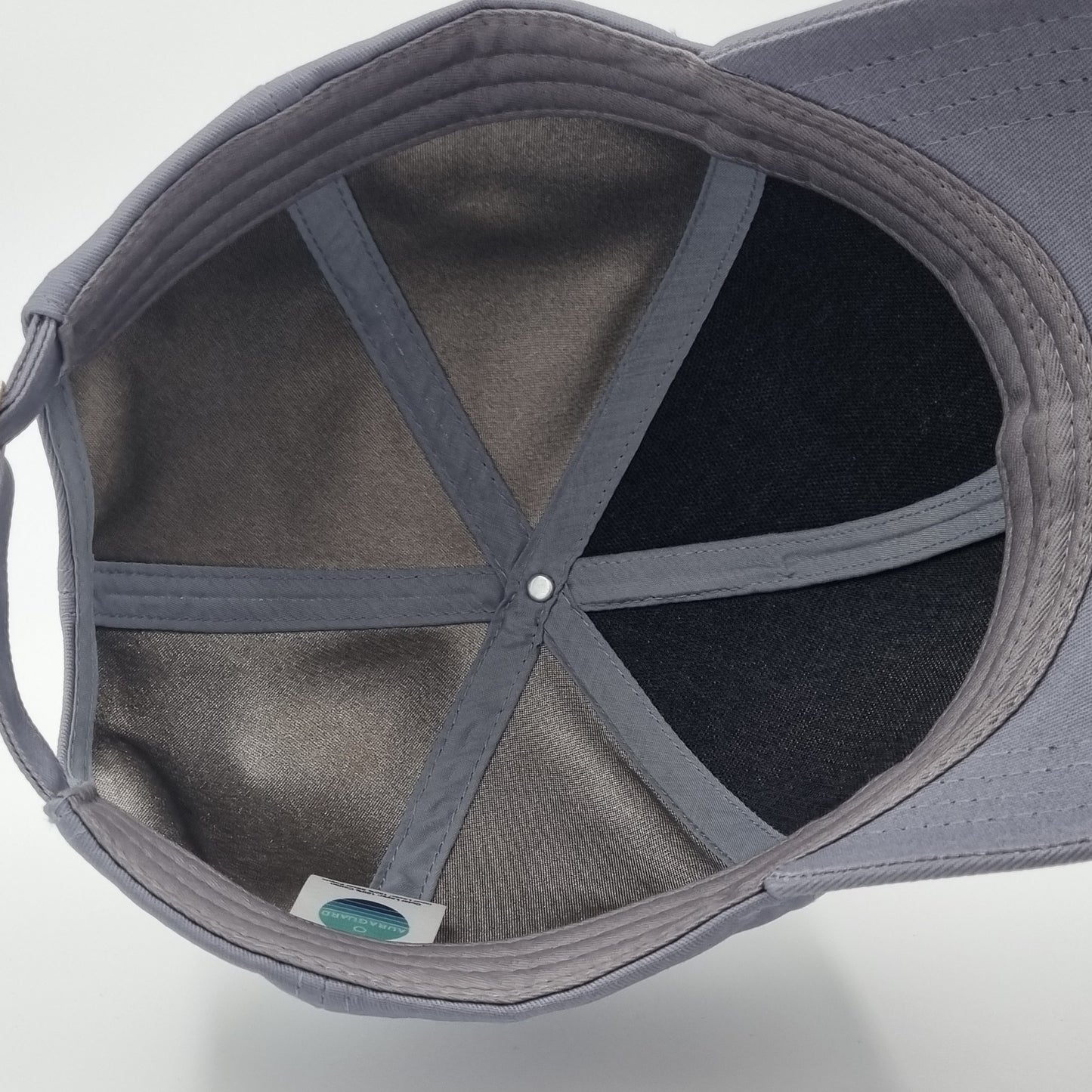 Charcoal cotton baseball cap with silver fabric lining for EMF protection, adjustable with a metal buckle for a comfortable fit.