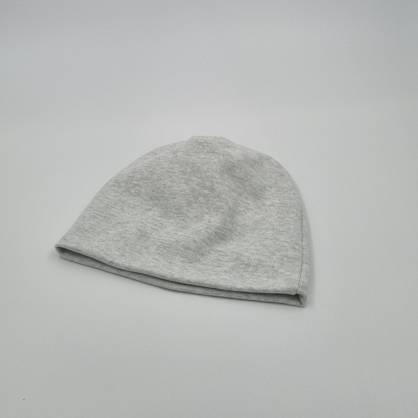 Silver baby beanie with a cotton exterior and silver fabric lining for EMF protection, providing a stylish and protective option for babies