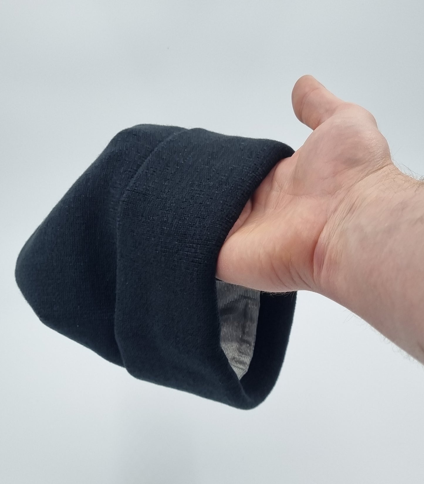 Black unisex winter beanie with thick acrylic outer layer and silver fabric lining for EMF protection, ideal for cold weather