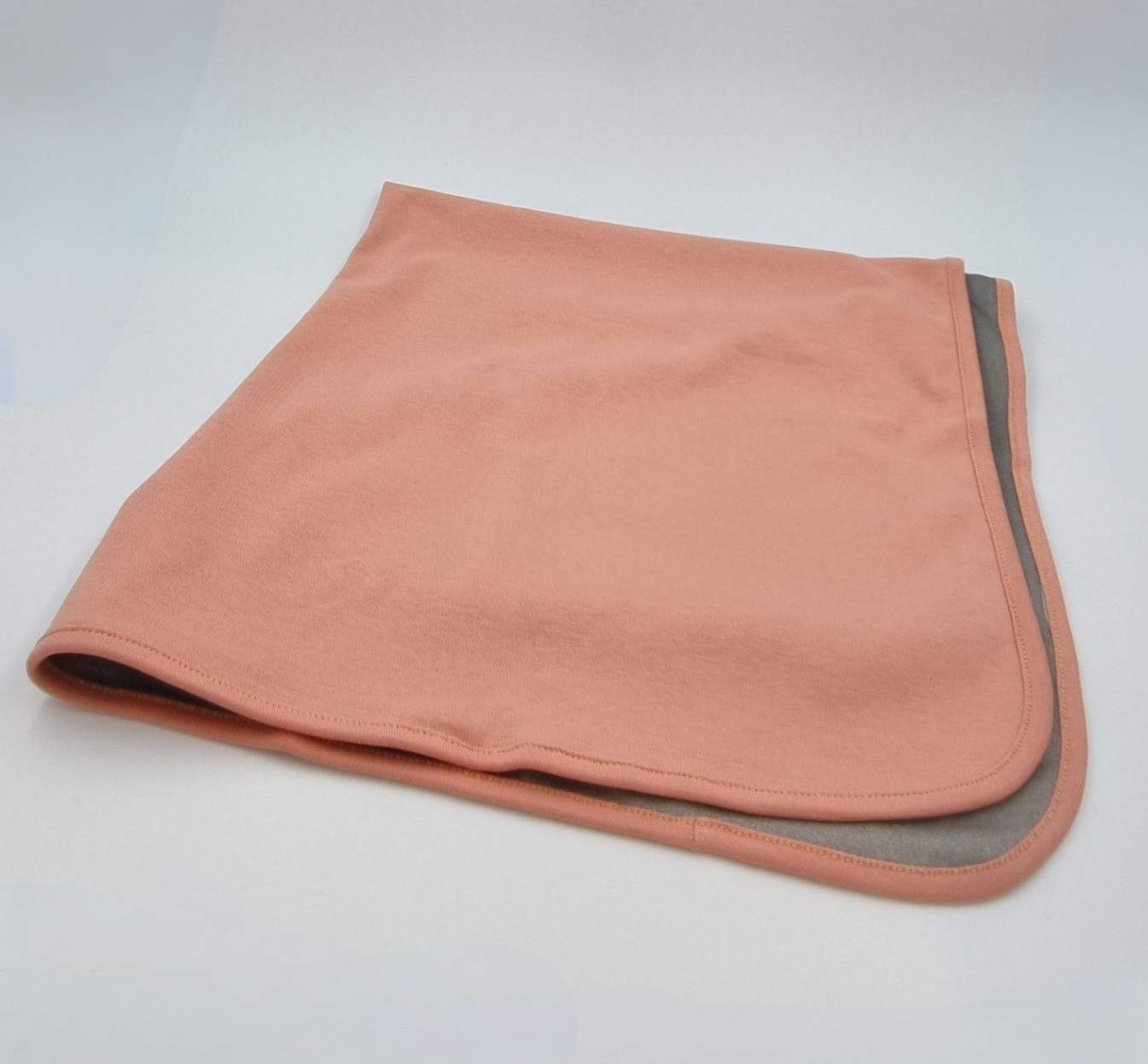 Cozy orange baby blanket featuring silver fabric lining for EMF protection, designed to ensure comfort and safety for babies